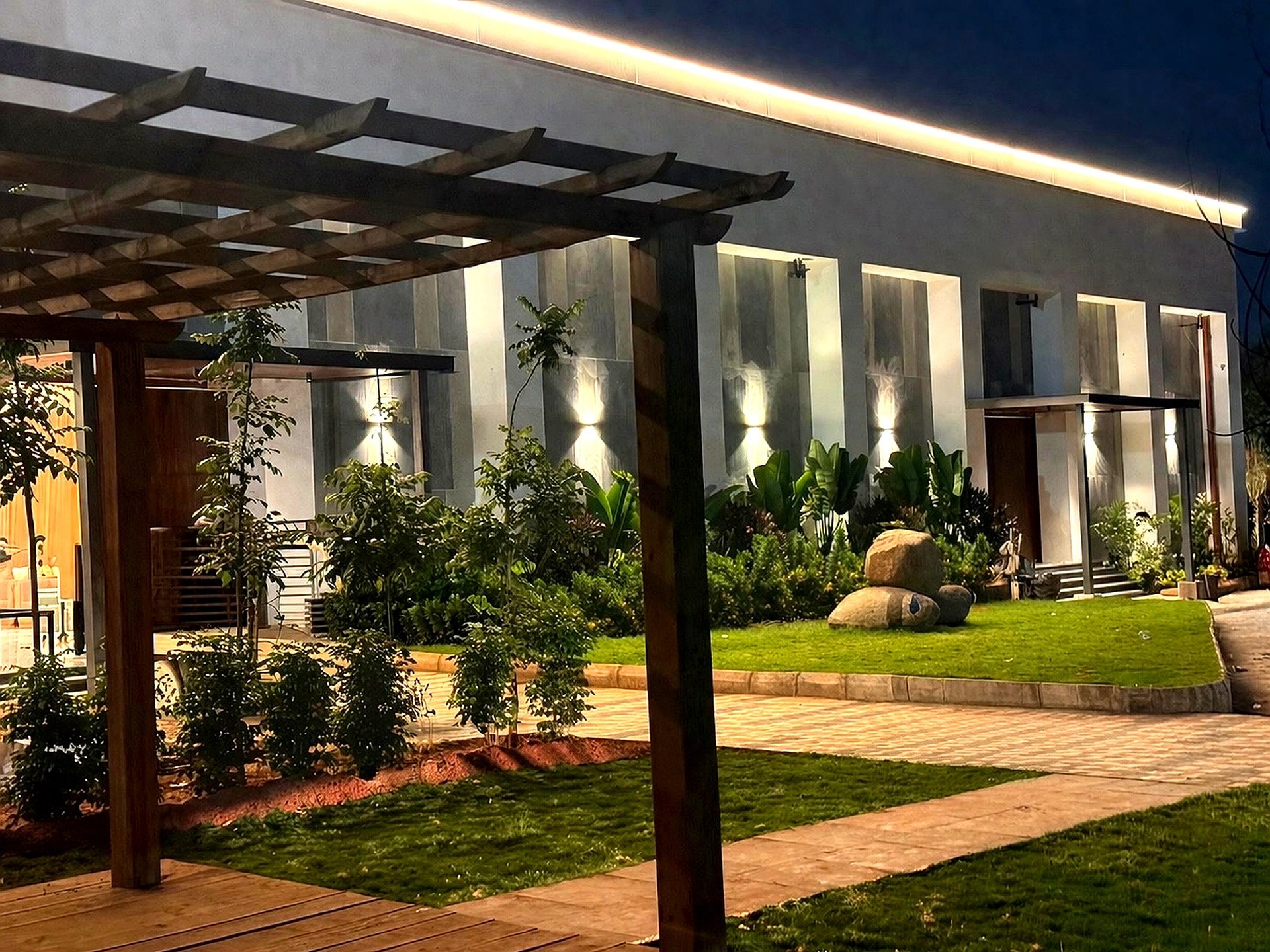 Landscaped exterior edge and lit walkways at Samruddhi